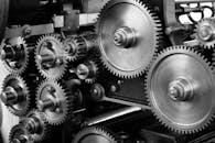 Close-up view of a complex industrial gear mechanism in black and white.