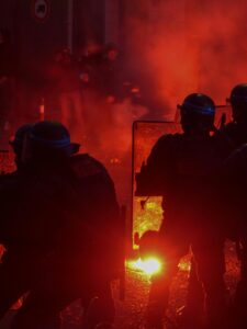 Silhouetted policemen during a heated protest at night in Paris, France.